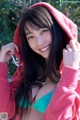 A young woman in a red hoodie posing for a picture.